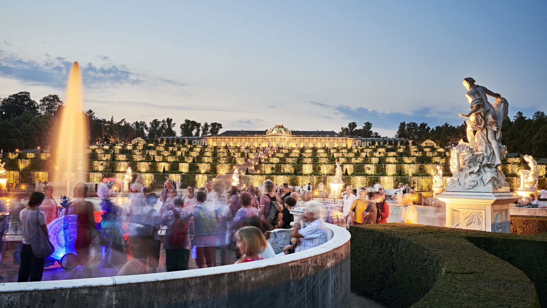 Illuminated Sanssouci Palace and fountain, crowd in the garden during the Potsdam Palace Night