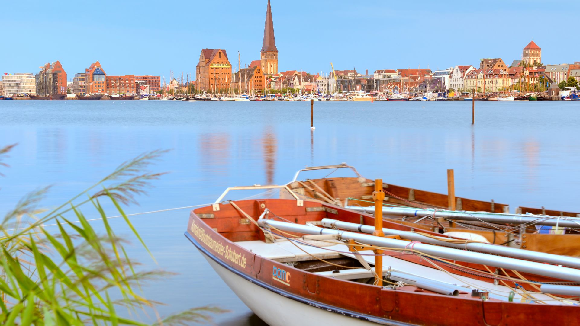 City harbor and skyline of Rostock`s old town with St. Peter`s Church from the banks of the Warnow River